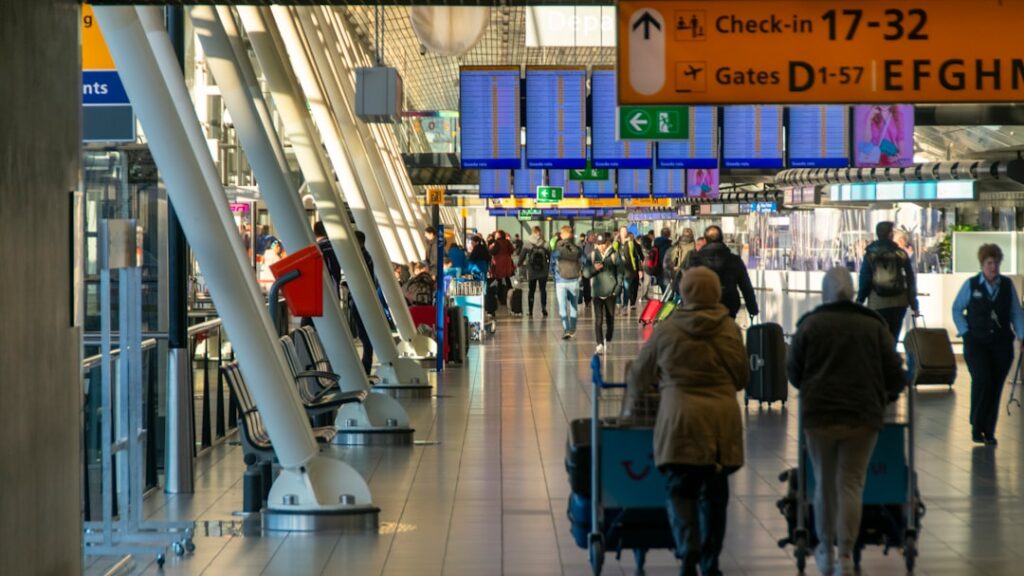 People walking in the check-in hall at Schiphol airport, Amsterdam, NL